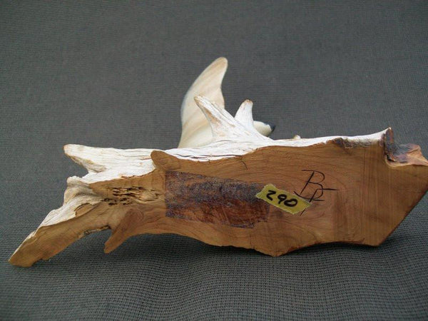 Miniature flying Canada Goose on driftwood stand